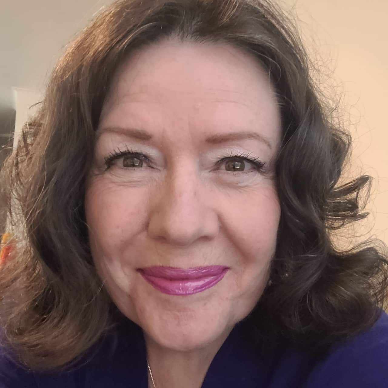 A woman with brown hair smiles