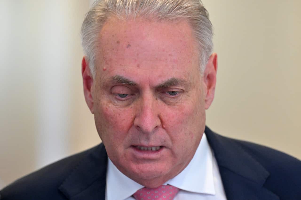 Don Farrell grimaces at a press conference.