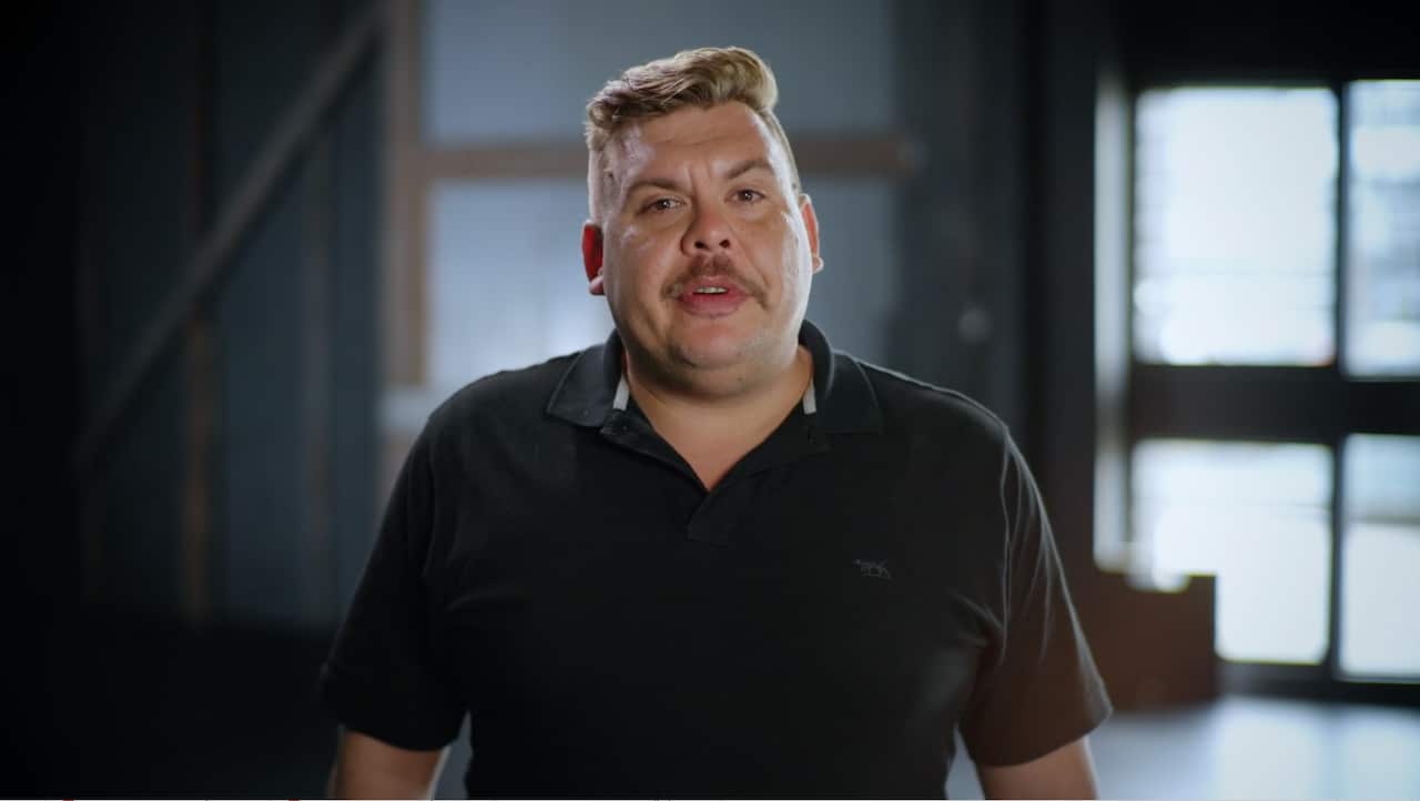 A man wearing a black T-shirt.