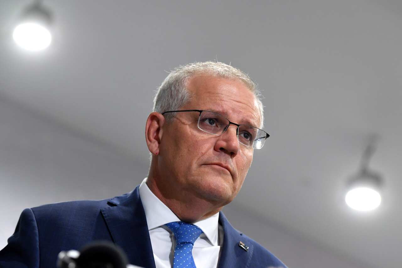 A man listening at a press conference.