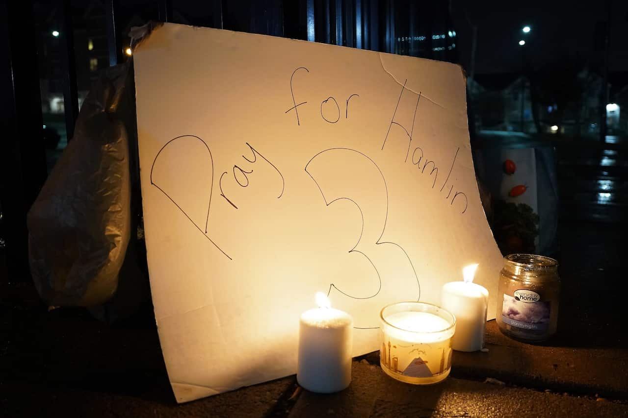 Candles and posters from supporters appear outside the University of Cincinnati Medical Center where Damar Hamlin is receiving medical treatment. 