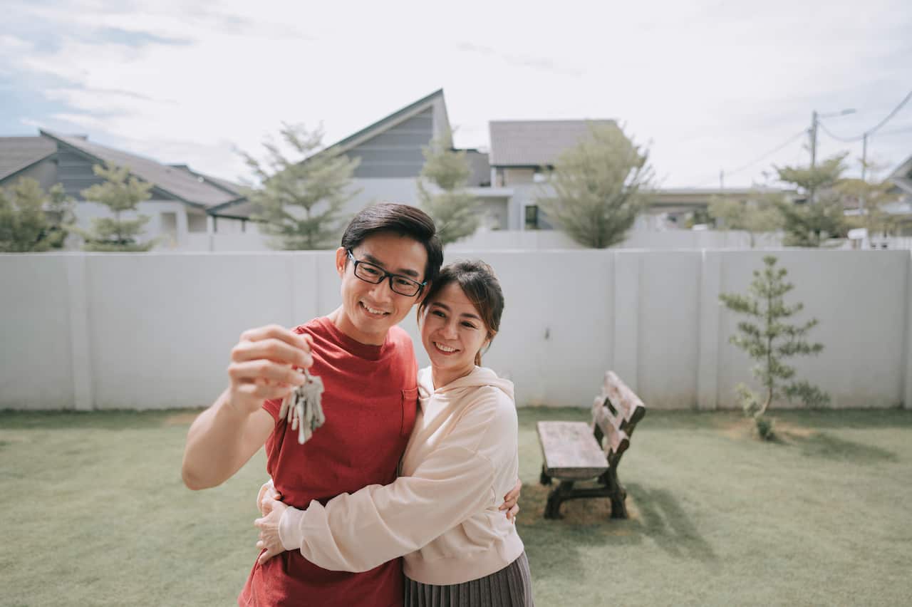 A young couple just received keys for their new house