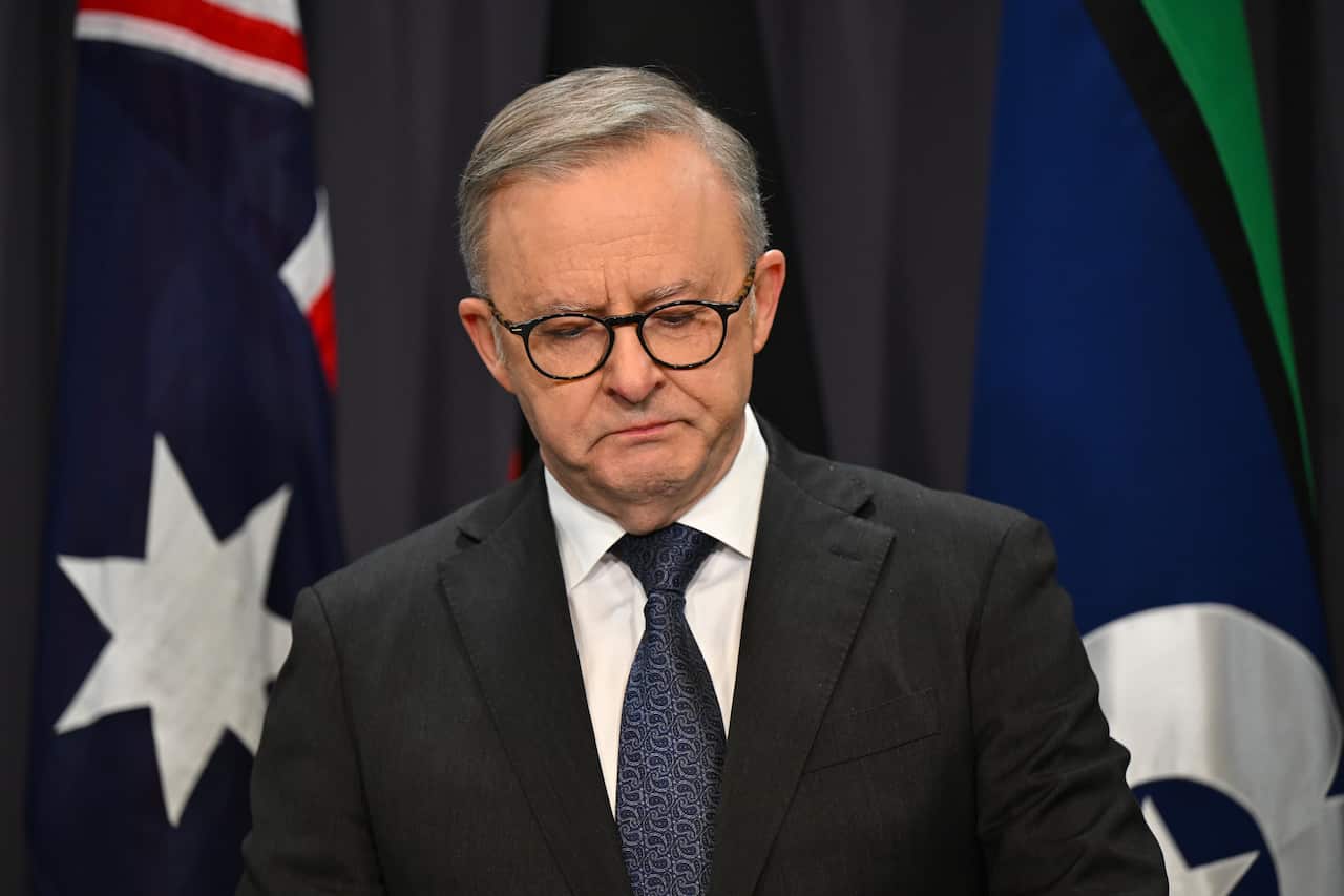 Anthony Albanese looking tearful at a press conference.