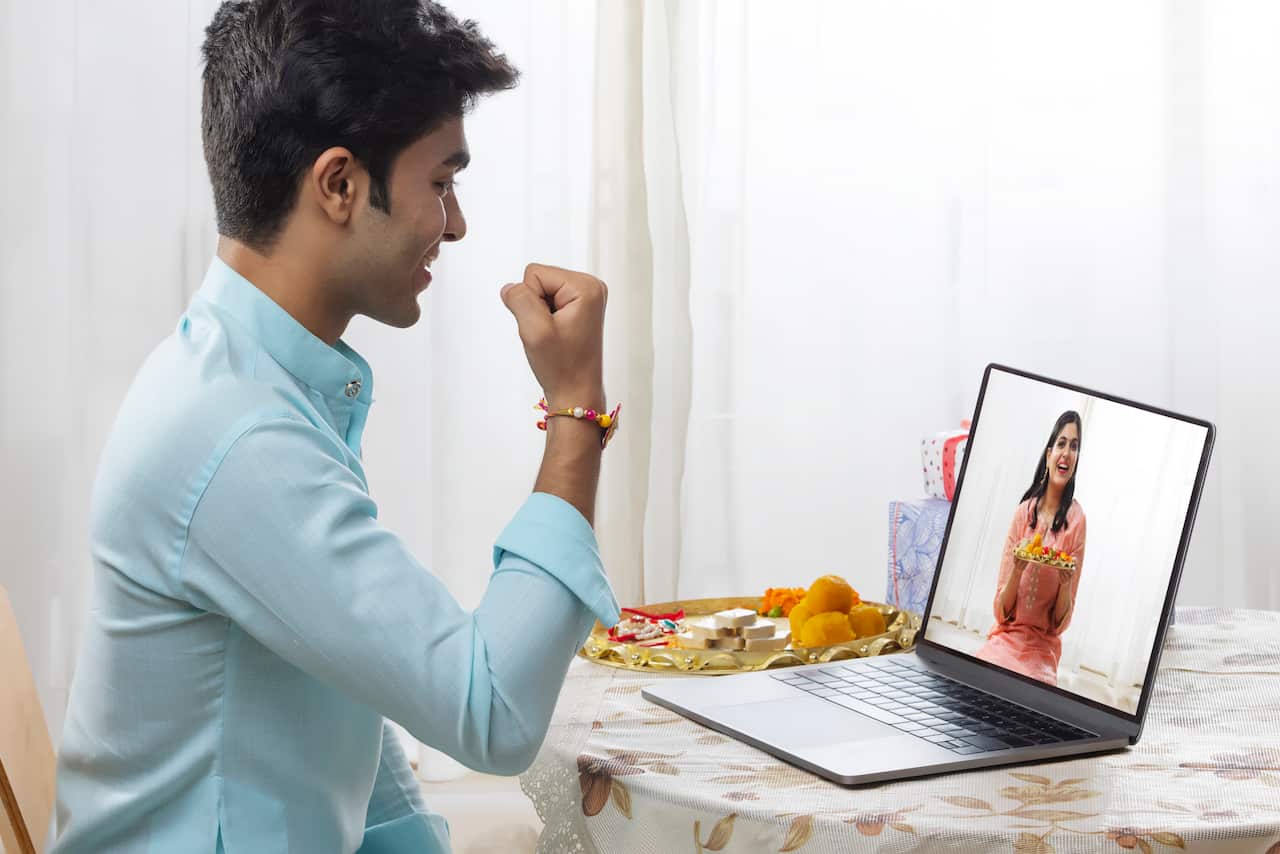 A HAPPY BROTHER AND SISTER CELEBRATING RAKHI ON VIDEO CALL
