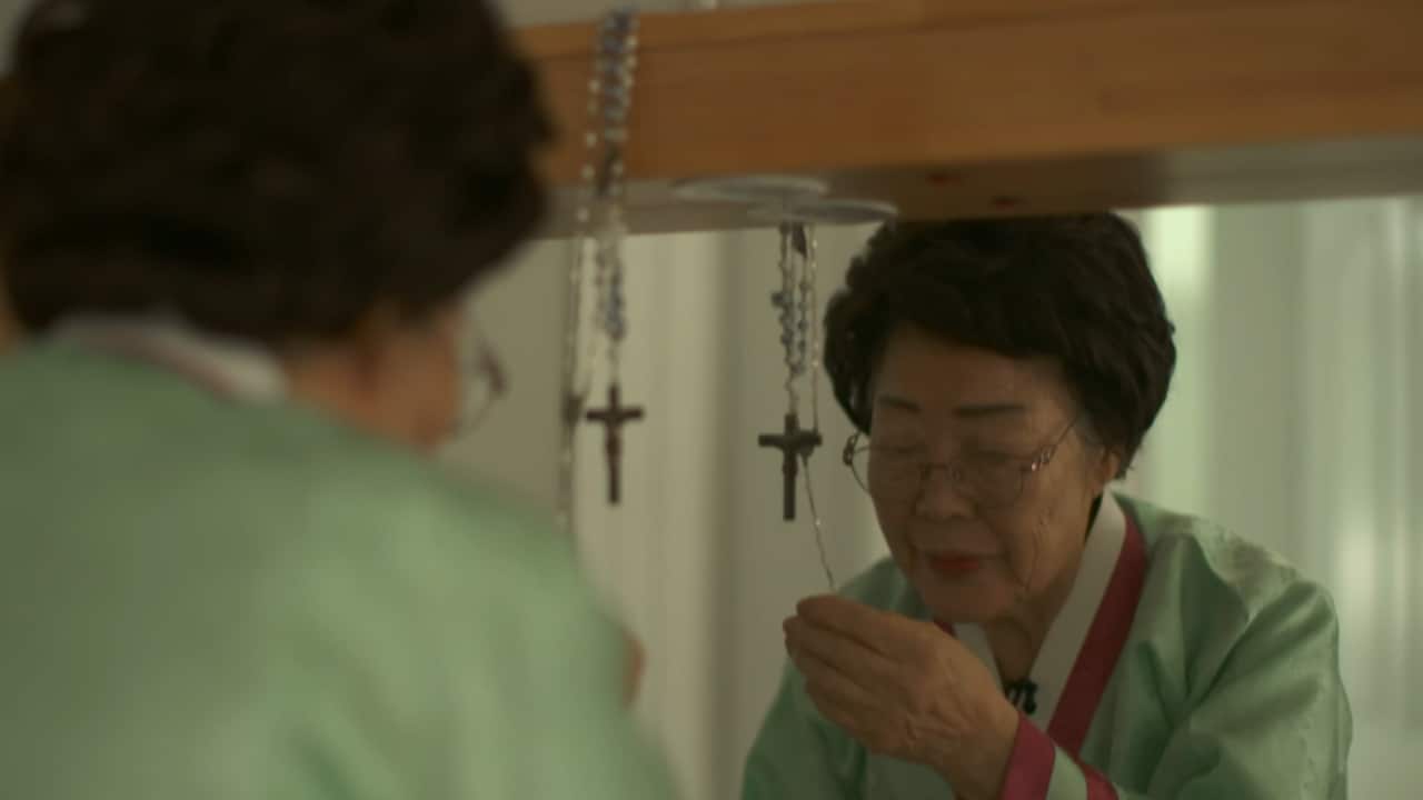 A woman holding a crucifix. 