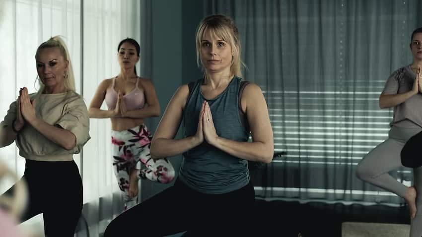 Women assume the tree pose in a yoga class.jpeg