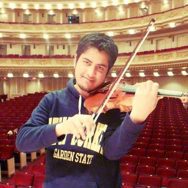 A man playing his violin at Carnegie Hall in New York