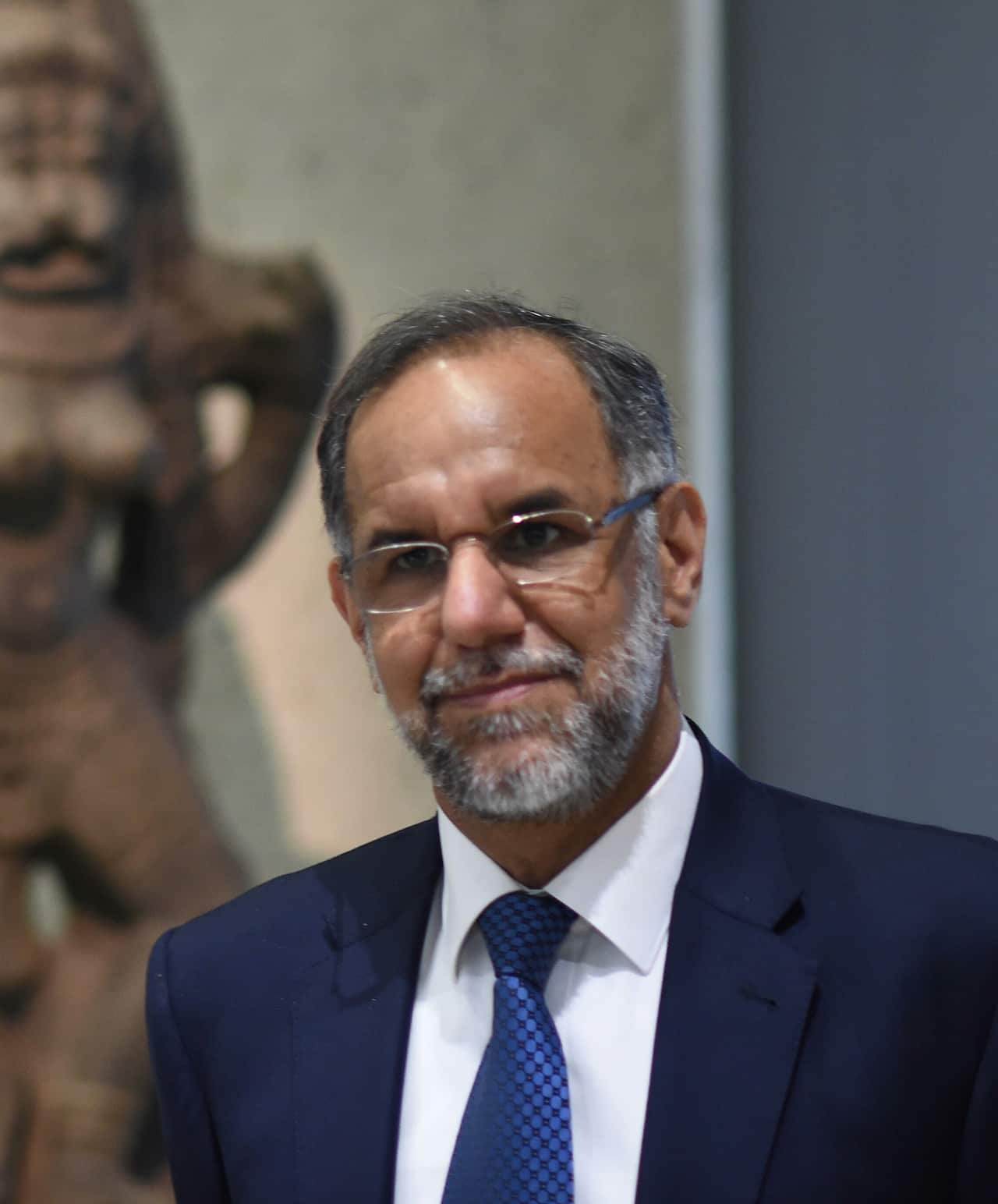 A man in a blazer, shirt and tie.