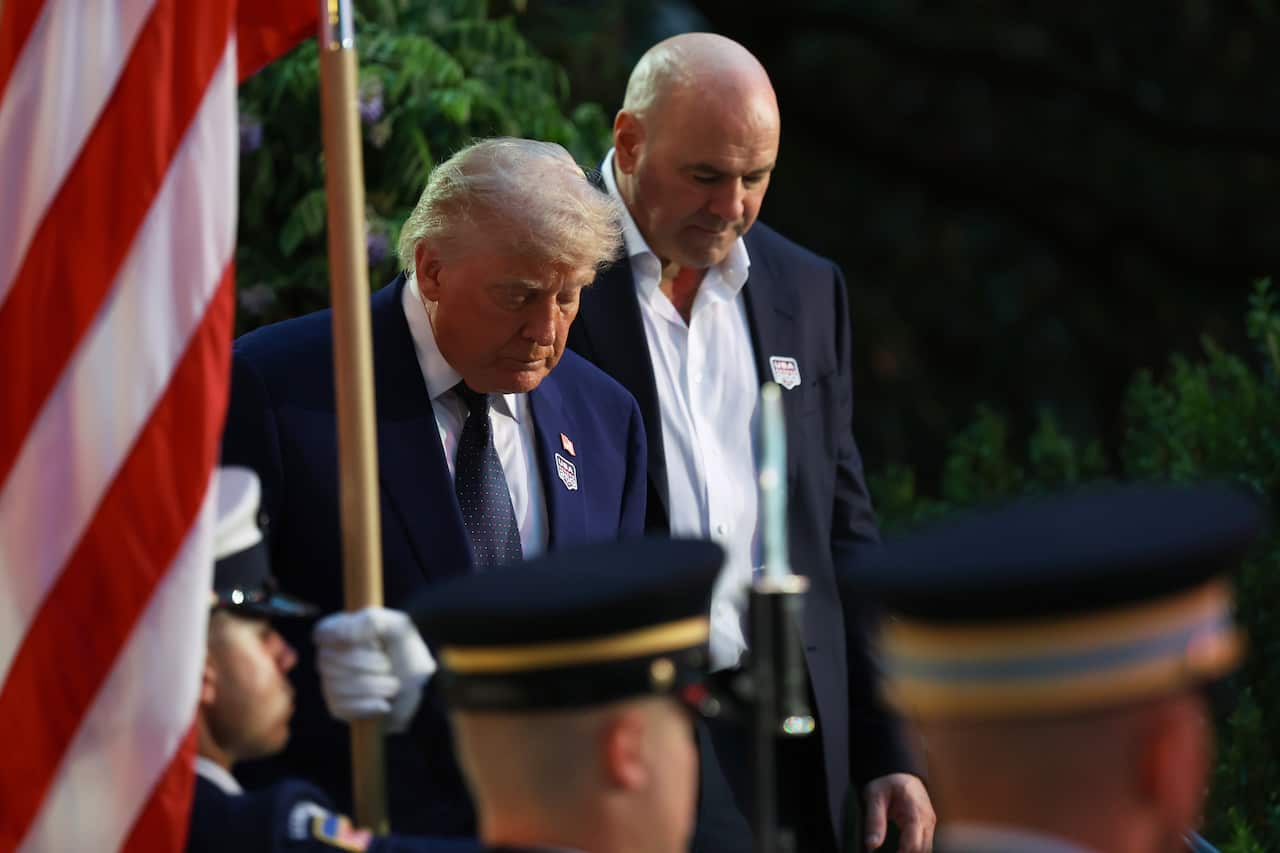 Donald Trump enters the White House surrounded by American flags and UFC CEO Dana White