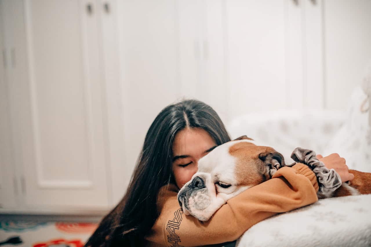 Female hugging a dog