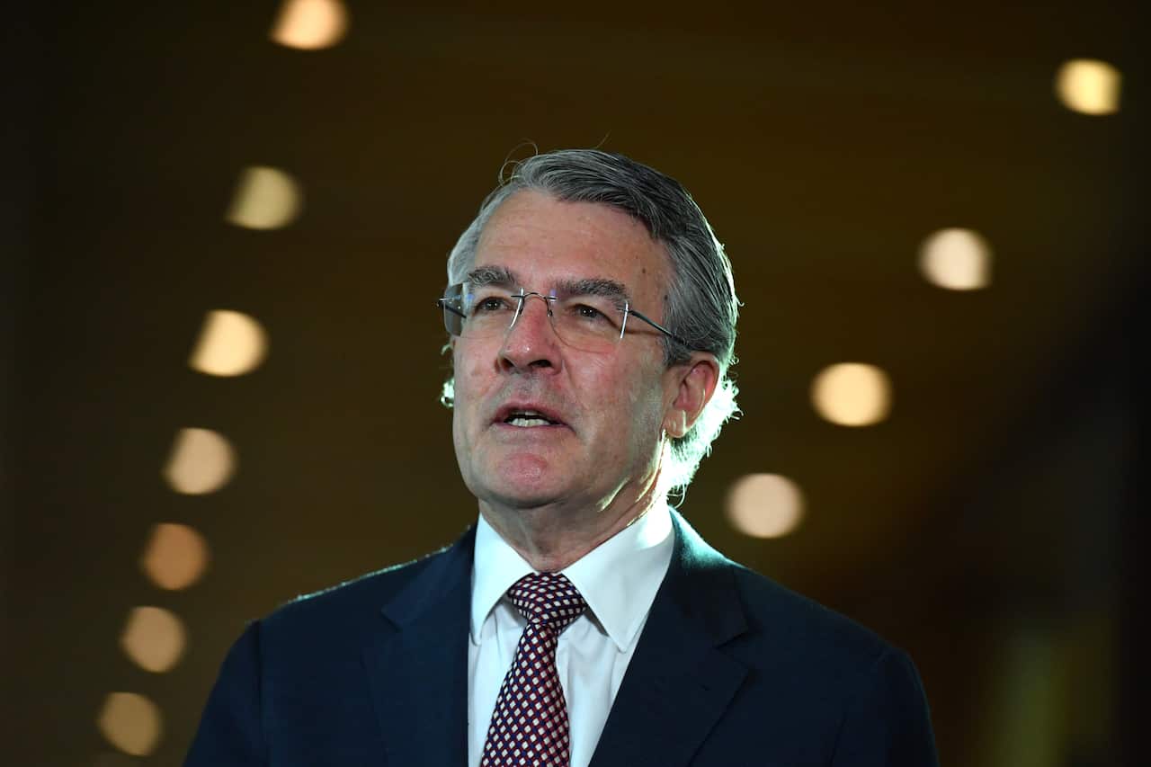  Mark Drefys is mid-speech in a suit