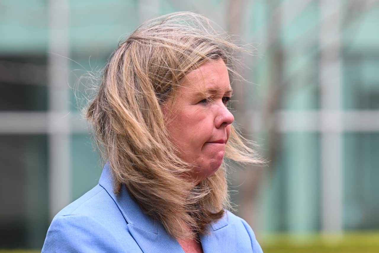 Bridget Archer stands with her hair in the wind.