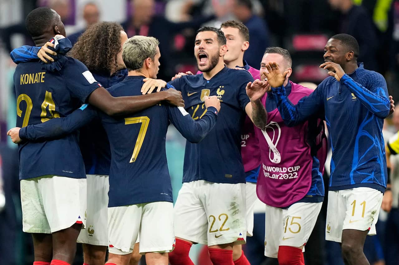 France's Theo Hernandez, center, celebrates with team mates after the World Cup semifinal soccer match between France and Morocco at the Al Bayt Stadium in Al Khor, Qatar