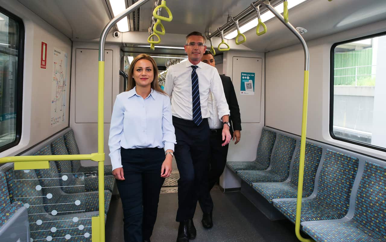 Tina Ayyad standing with NSW Premier Dominic Perrottet in a train carriage