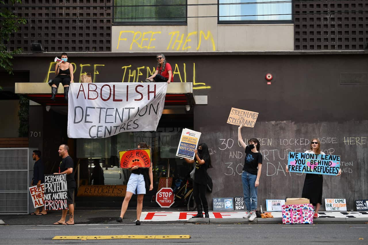 Protesters are seen outside of the Park hotel quarantine facility rallying for the release of detainees. 