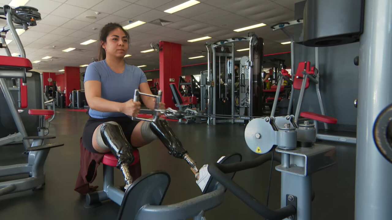 A woman working out on equipment in a gym.