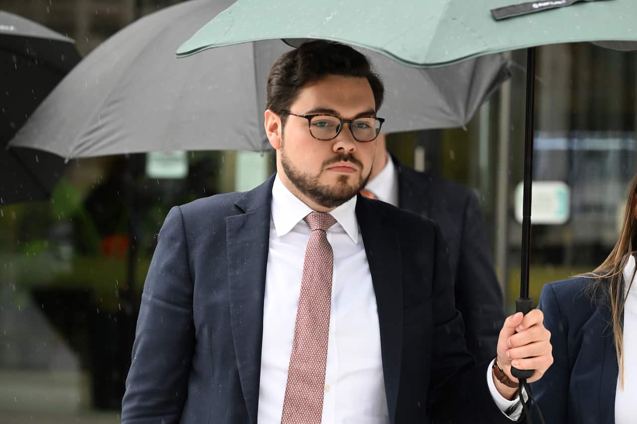 A man holds an umbrella