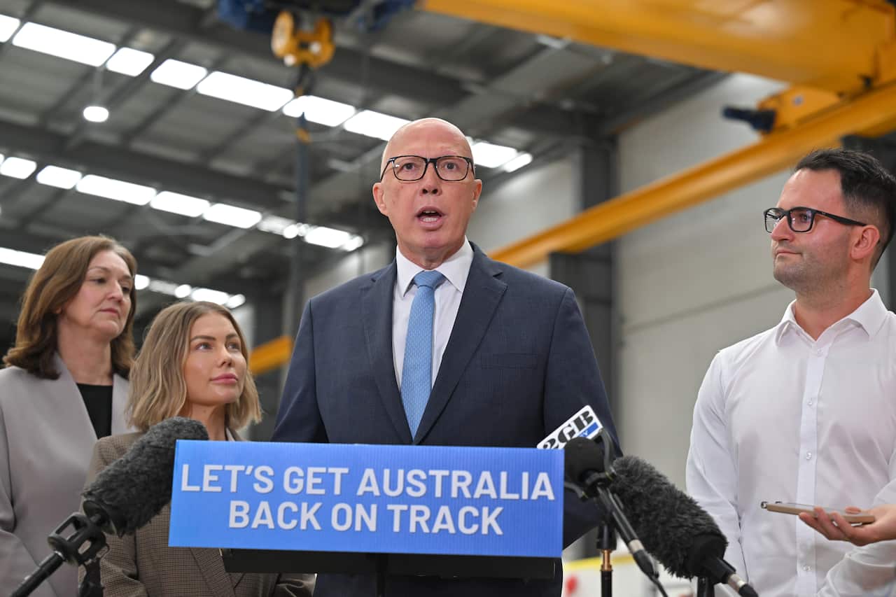 Peter Dutton address the media from a blue podium.