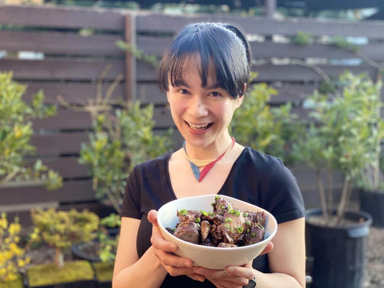 Photo Kim Cudia of Lola & Lola holding a bowl of chicken adobo..jpeg