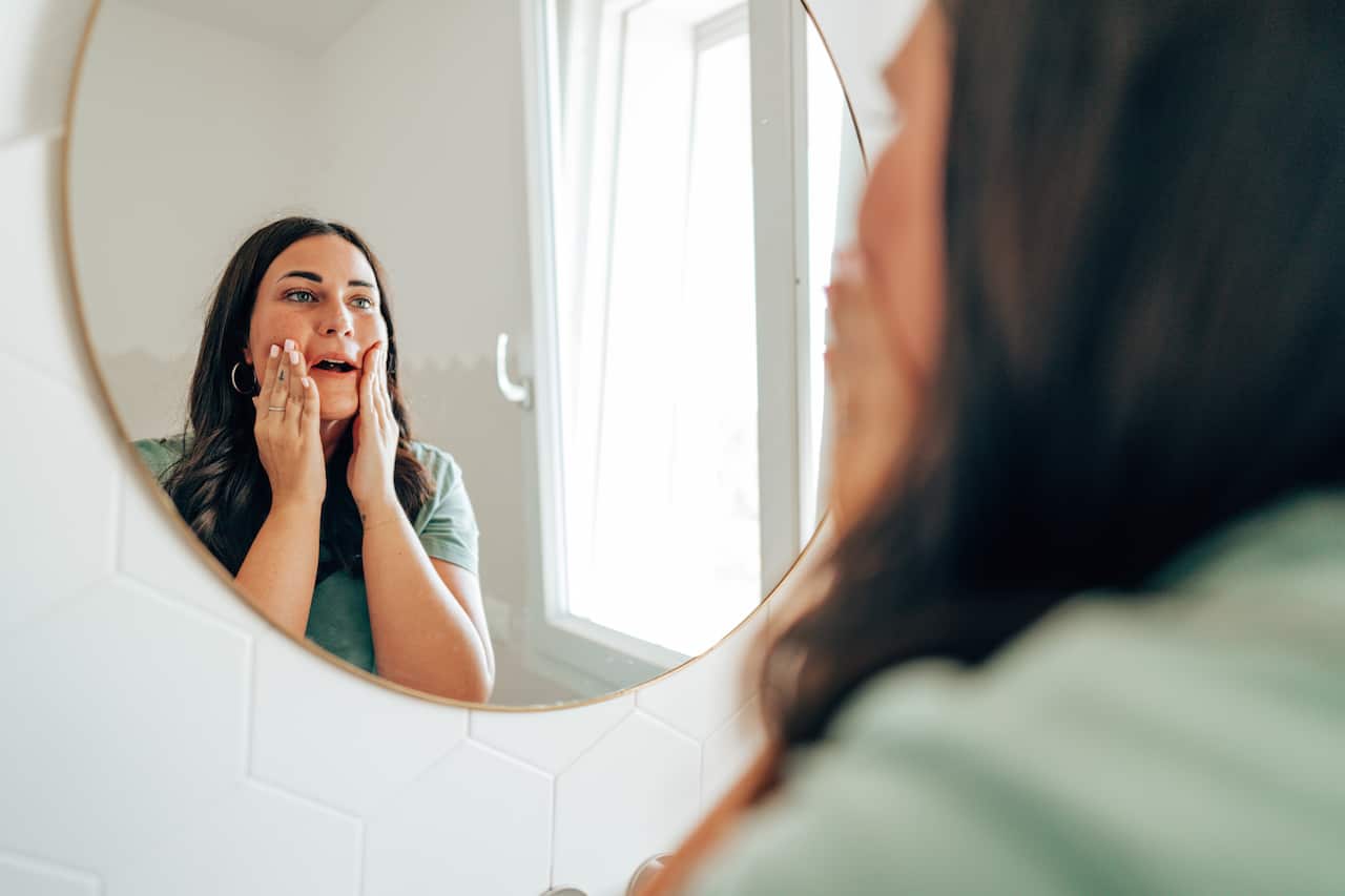 Woman looking in the mirror