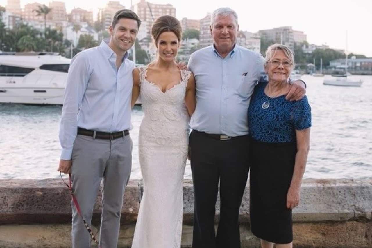 Rien, his sister, his father and his mother standing side by side at his sister's wedding. 