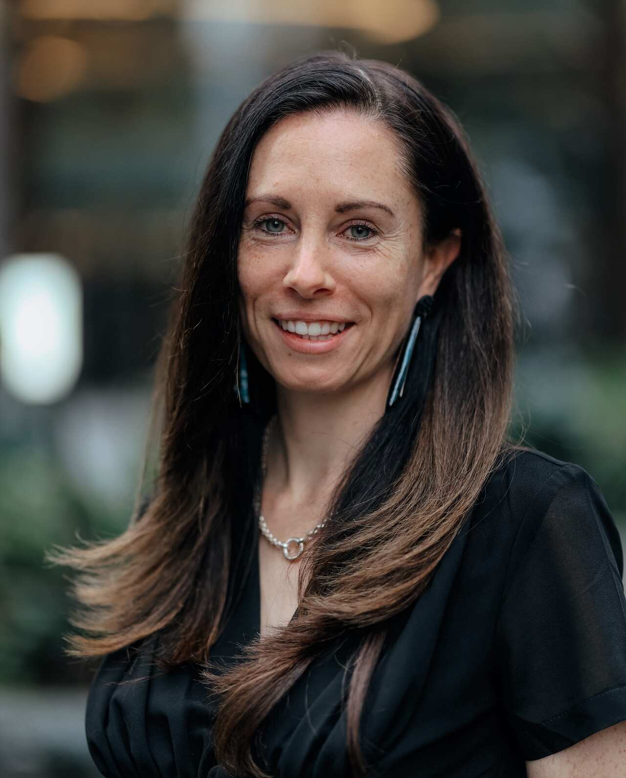 Social Traders CEO Tara Anderson standing in a black top. 