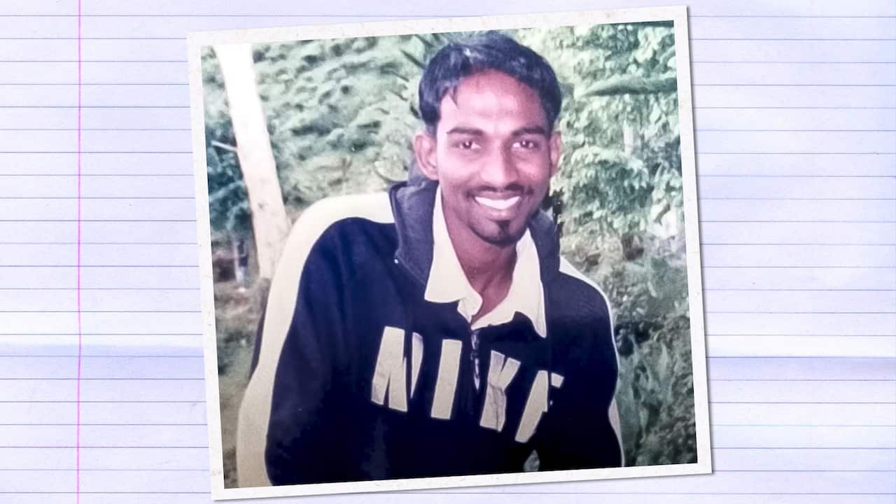 A photo of a man wearing a black tracksuit with Nike written in large white letters across the chest