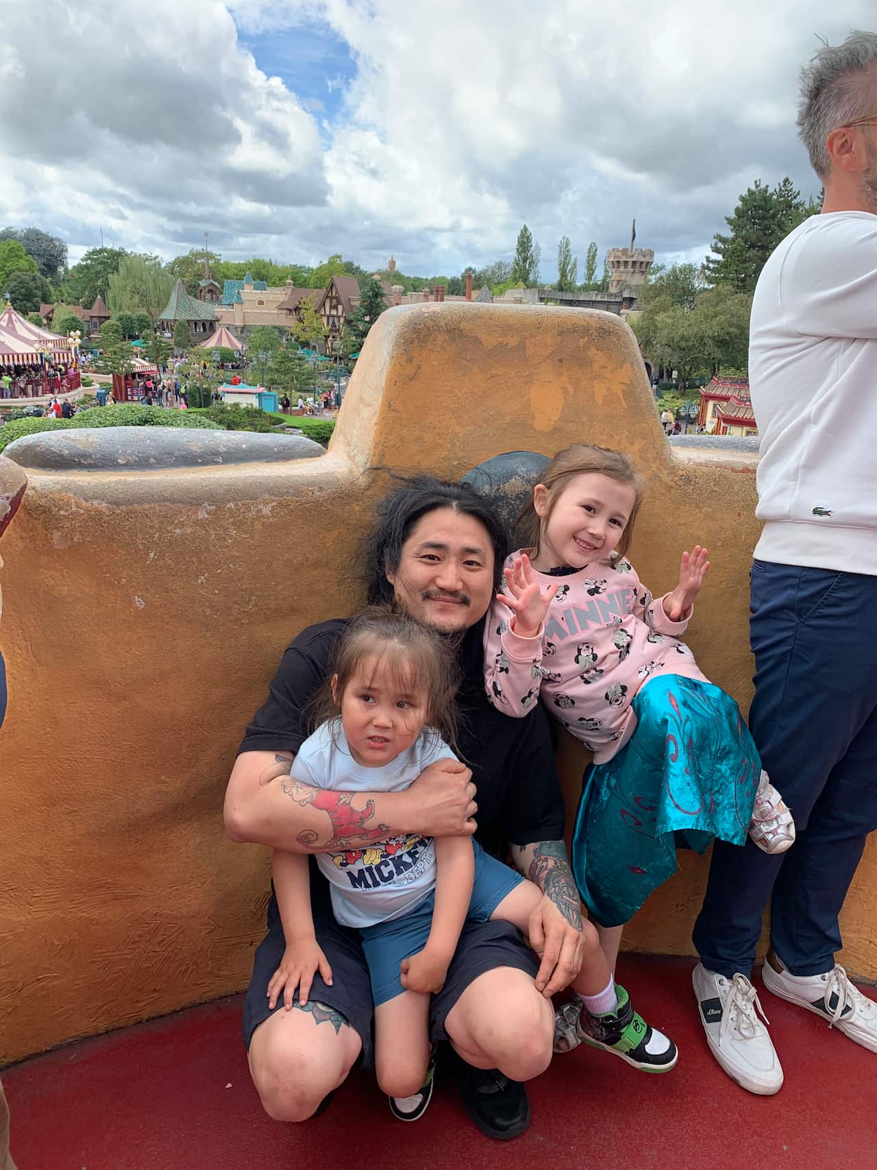 A man holding two children