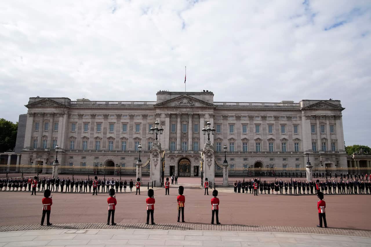 King's Guard soldiers stand outside Buckingham Palace during Queen Elizabeth II funeral ceremonies in central London.