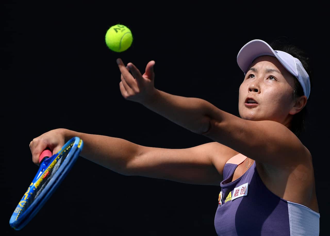 Peng Shuai serves a ball during a tennis match.