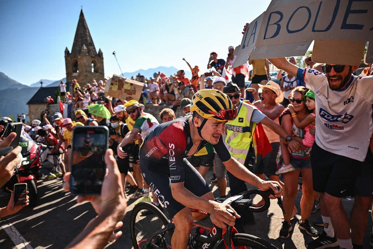 Tom Pidcock battles through the fans and up the climb of the Alp D'Huez on Stage 12 of the 2022 Men's Tour de France.