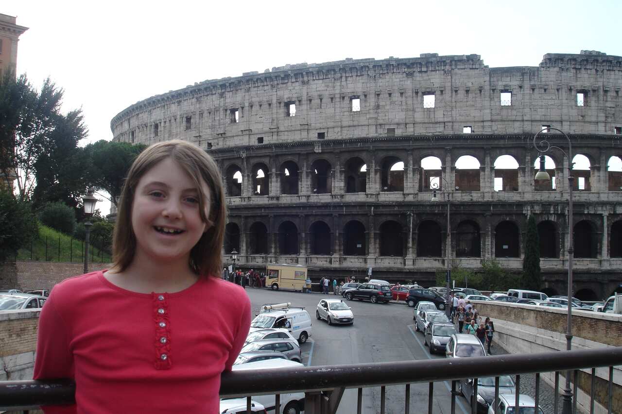 Therese as a child with the Coliseum in the background in Rome