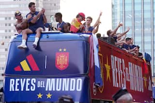 People on top of a parade bus celebrate