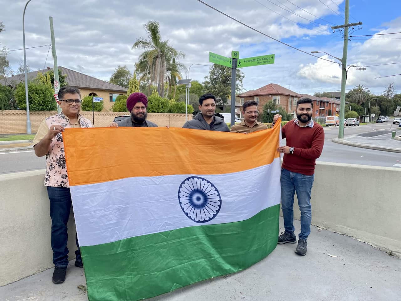 A group of people hold the Indian flag.