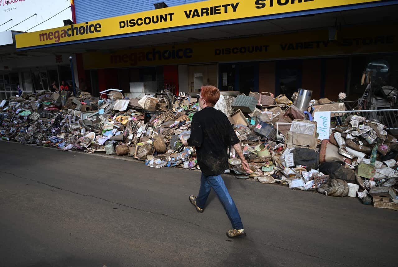 Piles of flood-damaged goods line a main street in Lismore as residents return to their properties to survey the damage following unprecedented storms and the worst flooding in a decade.  
