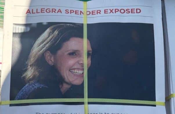 A cropped image of one of a pile of pamphlets bound with yellow plastic, the pamphlet features the face of Allegra Spender and the words Allegra Spender exposed".