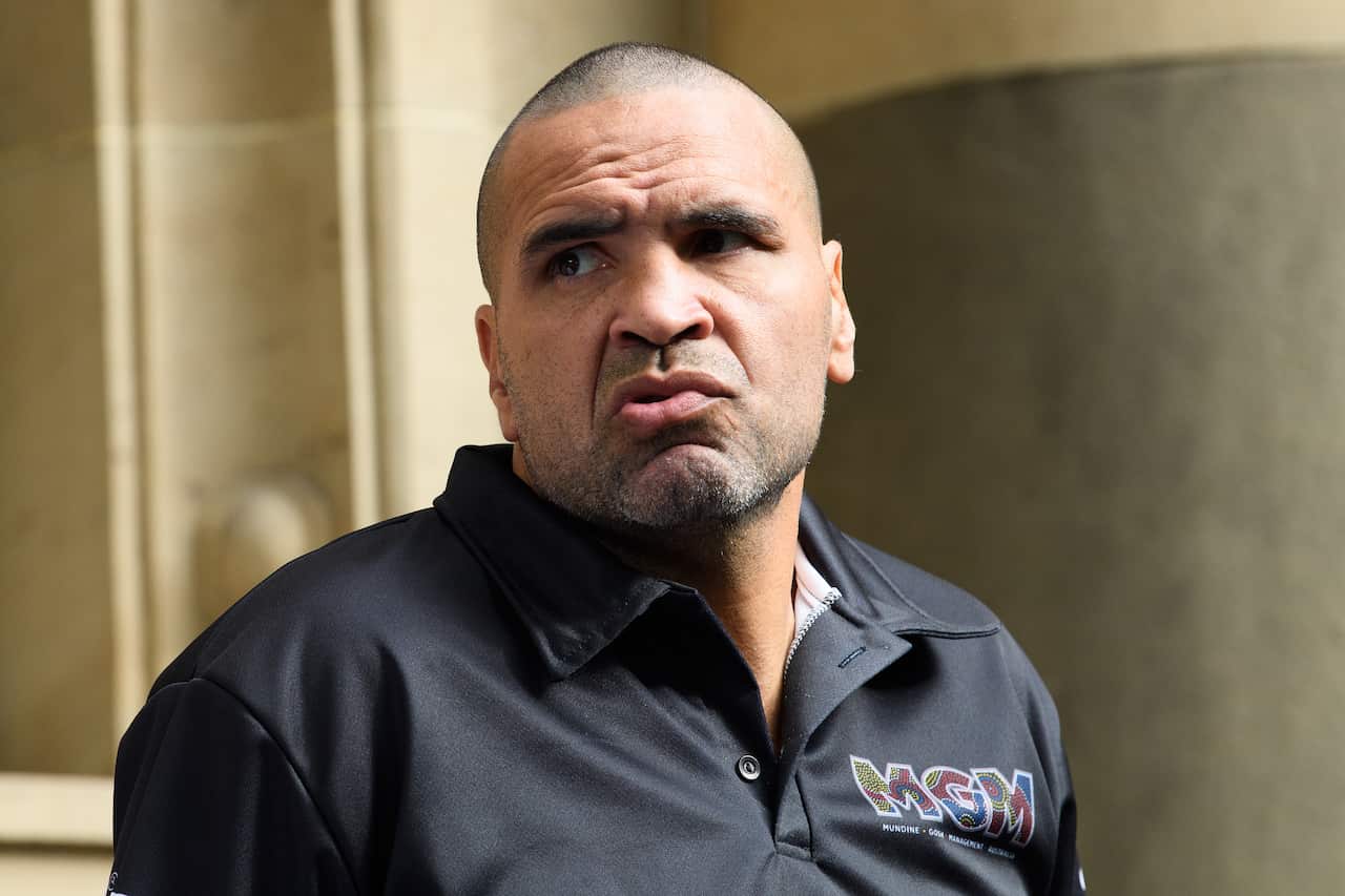Anthony Mundine wearing a black shirt outside