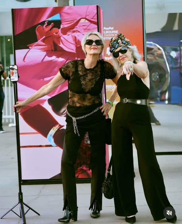 two older ladies posing in all black outfits