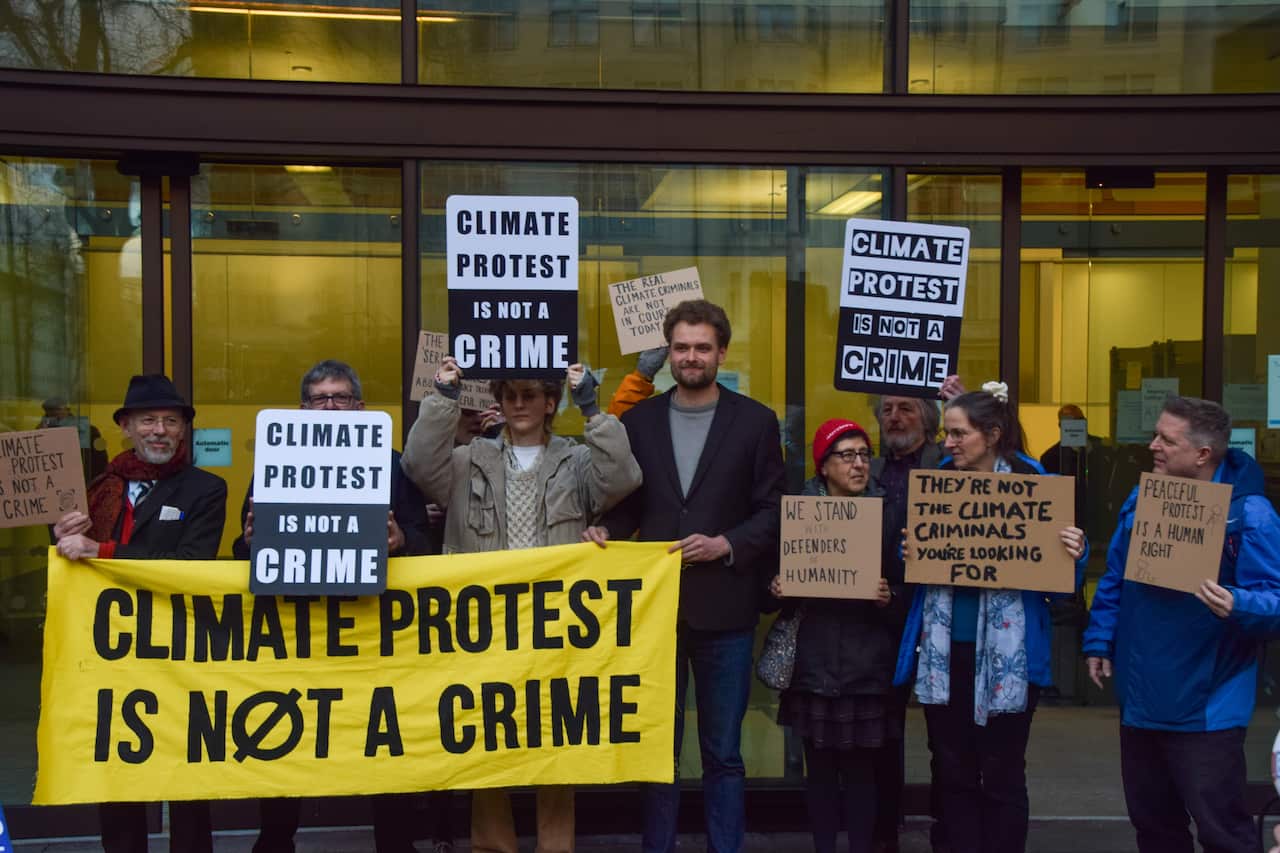 A group of climate activists holding signs