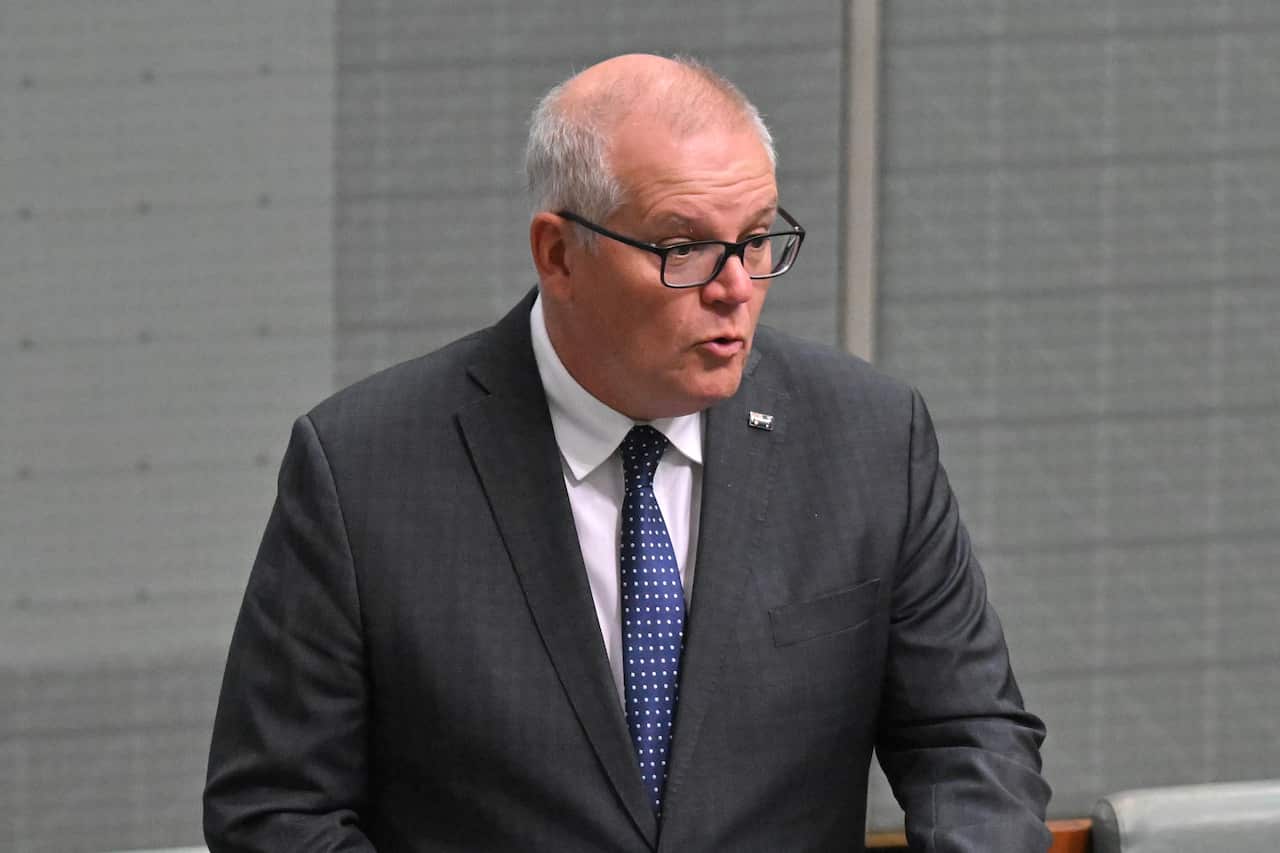 Man in tie and suit speaking.