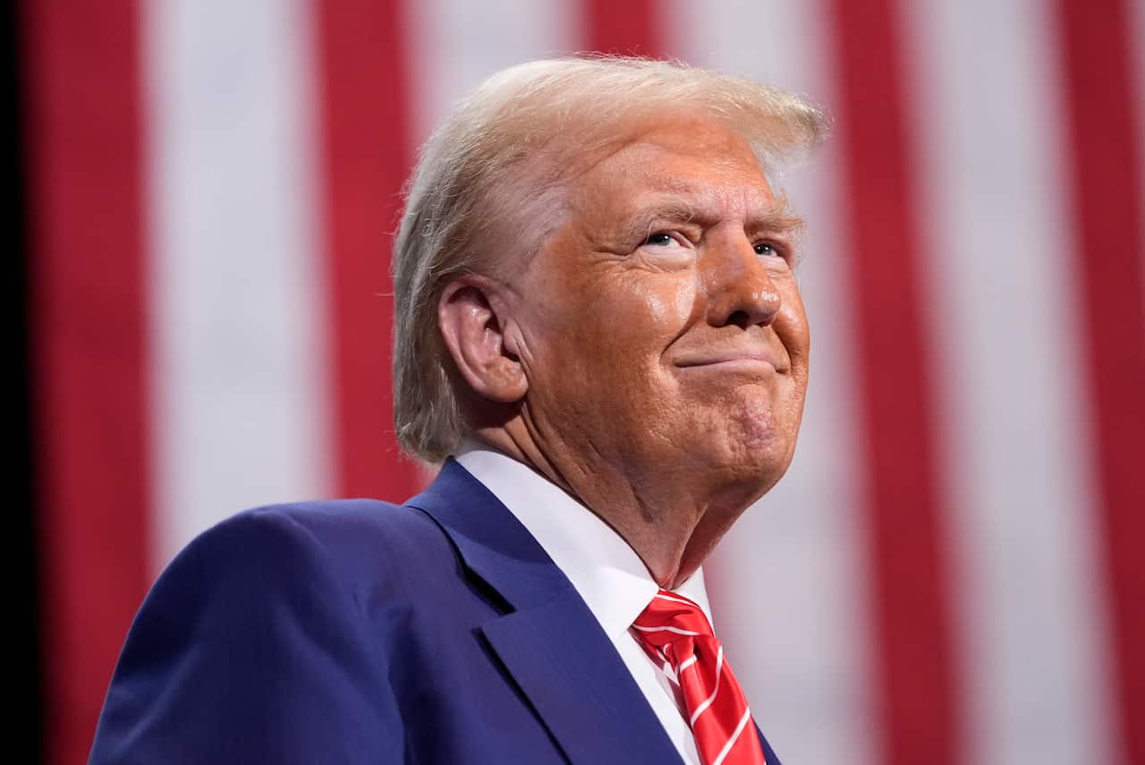 Close-up of Donald Trump smiling at a campaign event.