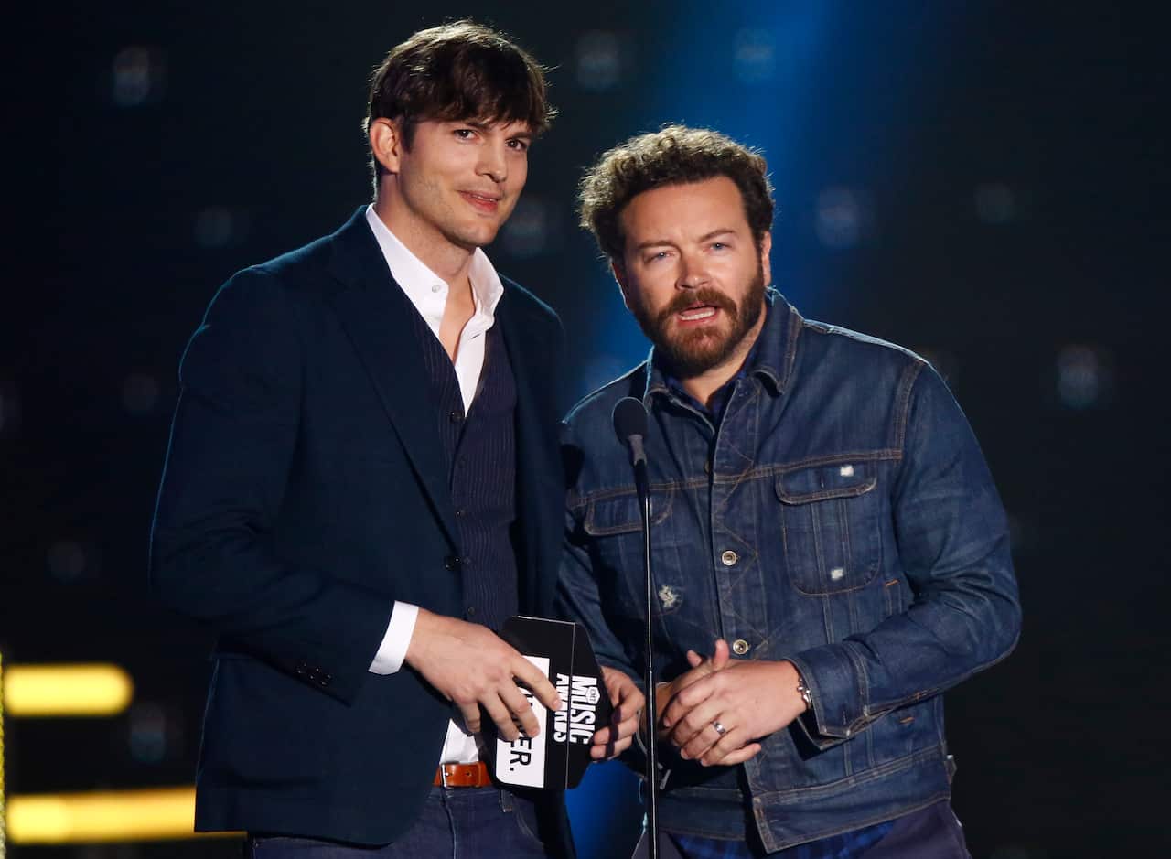 Actors Ashton Kutcher, left, and Danny Masterson standing on stage next to each other