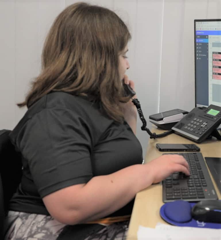 Rita Nichola in a black top, answering a phone at TLC in Sydney.