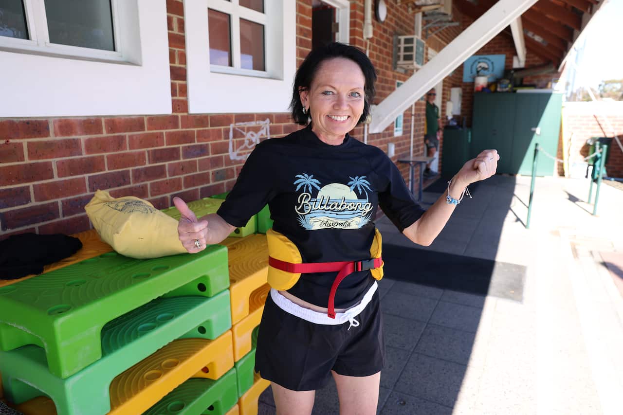 A woman in a swimming costume and life vest