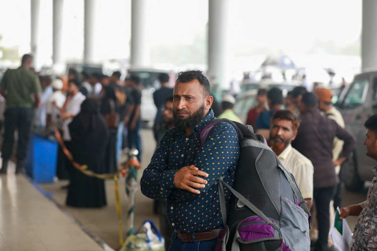 Frustrated passengers stand frustrated at an airport.