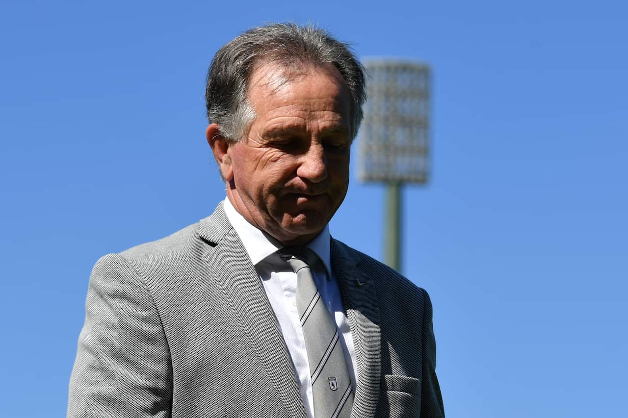 A man in a grey suit jacket and a white shirt.