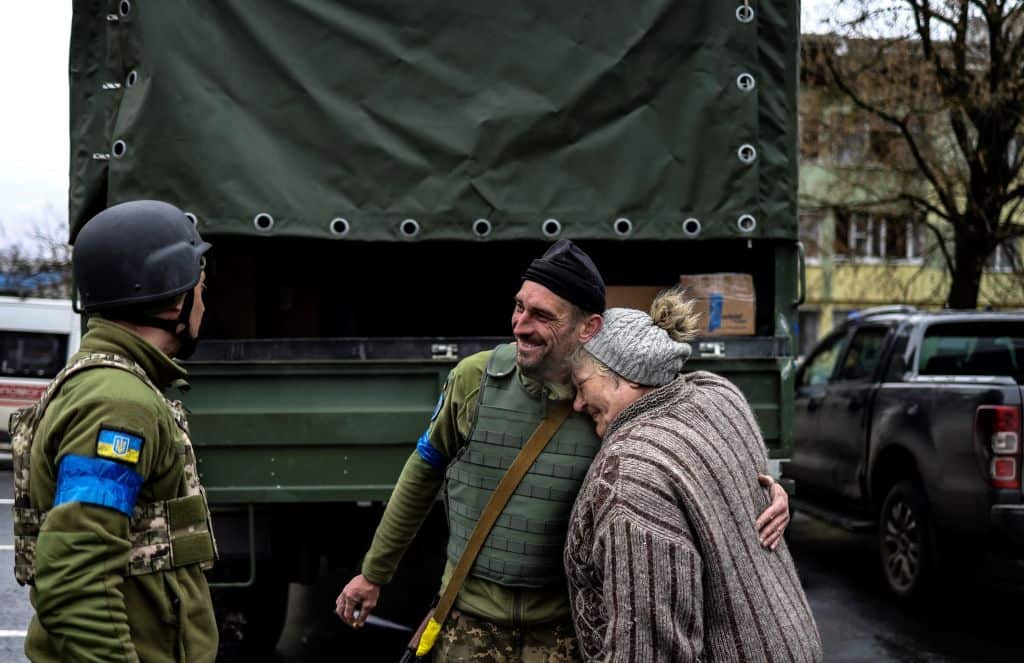 An elderly woman embraces an Ukranian soldier in Bucha, northwest of Kyiv.