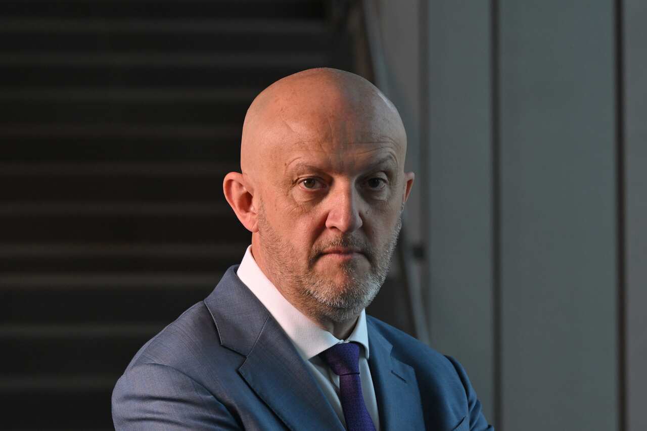 ASIO head Mike Burgess staring into camera.