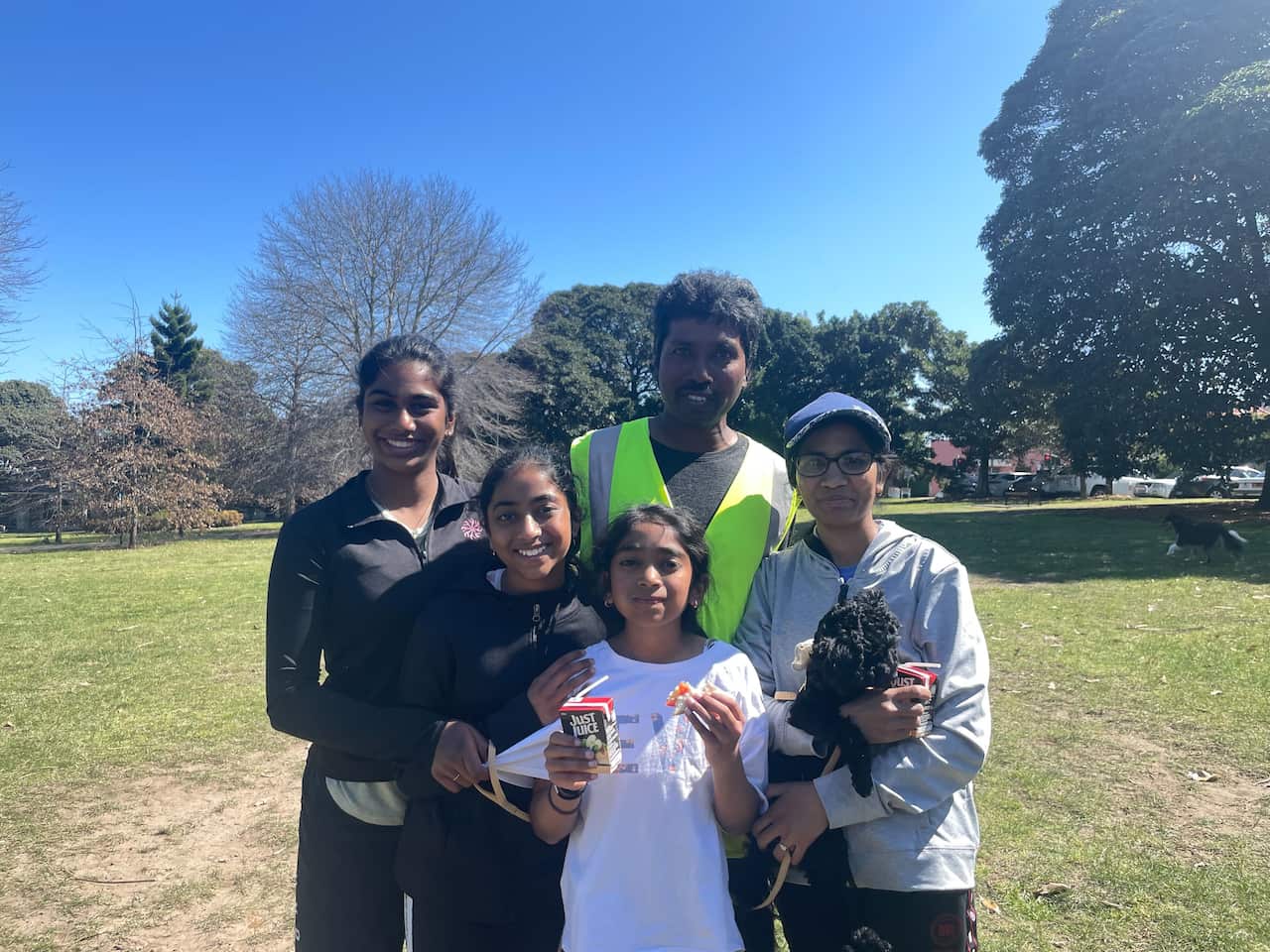 5 people posed for a portrait smiling.