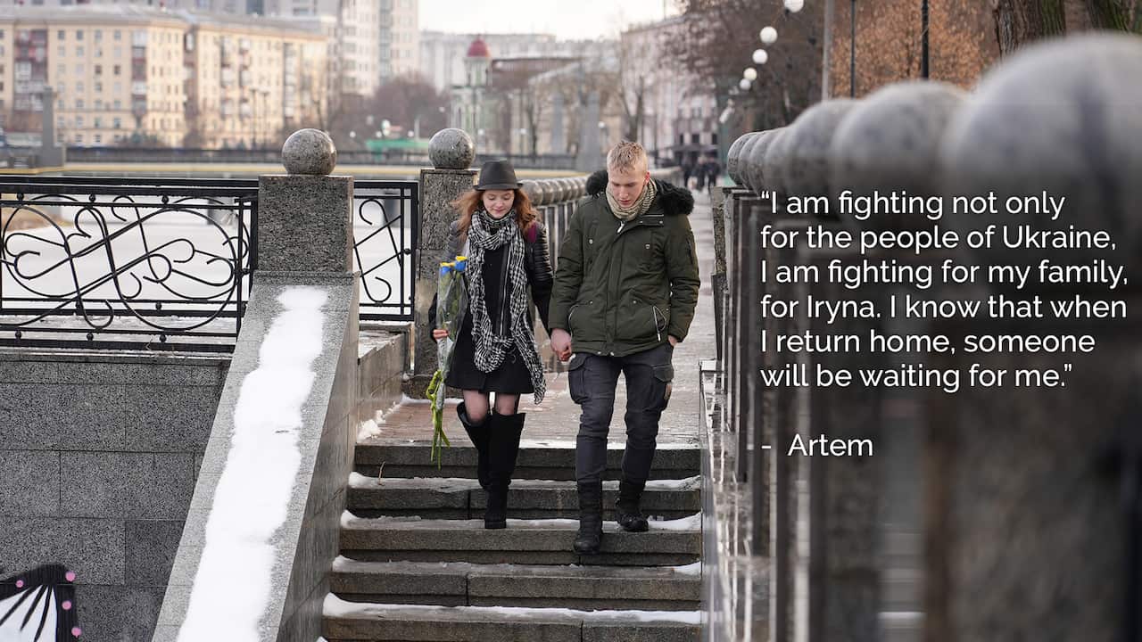 Two teenagers holding hands walking down an outdoor staircase.